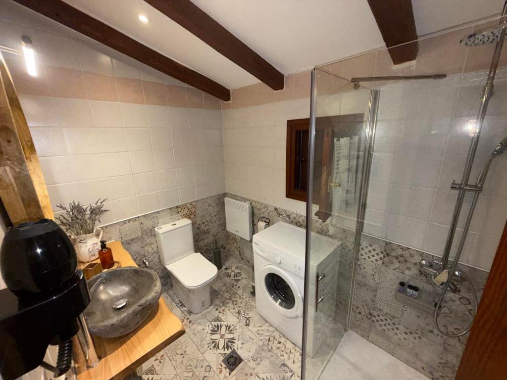 a bathroom with a shower and a toilet and a sink at Aggelos Gardenhouse of Volos in Volos
