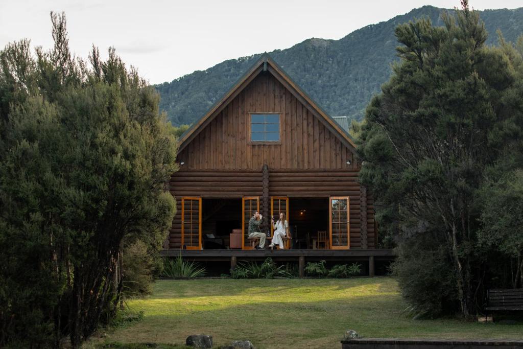 two people standing on the porch of a house at Lyford Luxury Escape - ML21963 in Mt Lyford