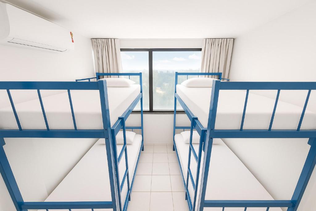 Postel nebo postele na pokoji v ubytování Joy Hostel & Suítes