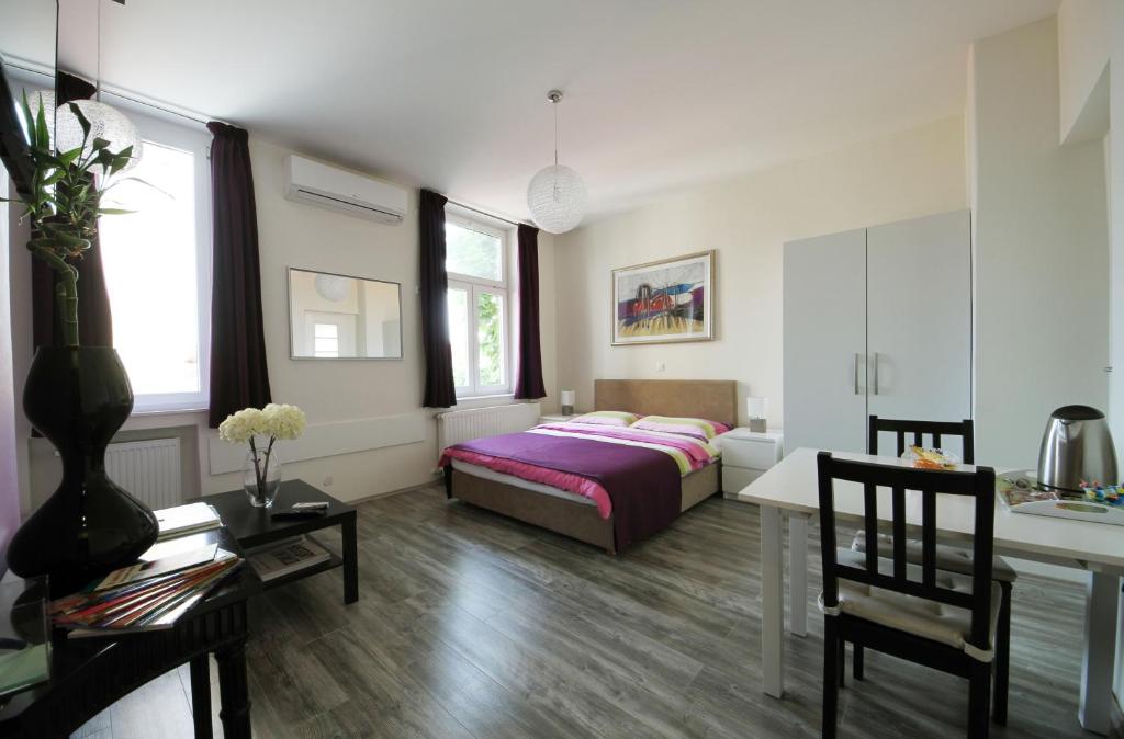 a bedroom with a bed and a table and a desk at Studio Dolac Centar in Zagreb