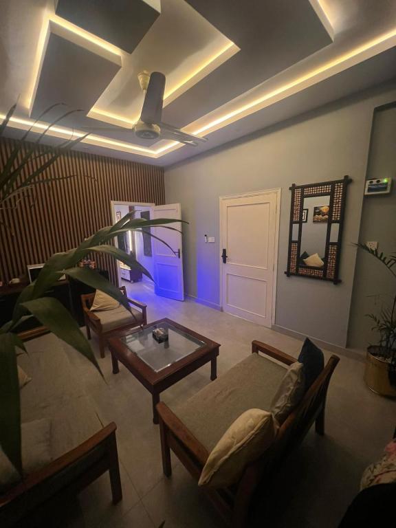 a living room with a couch and a table at Private in Dargai