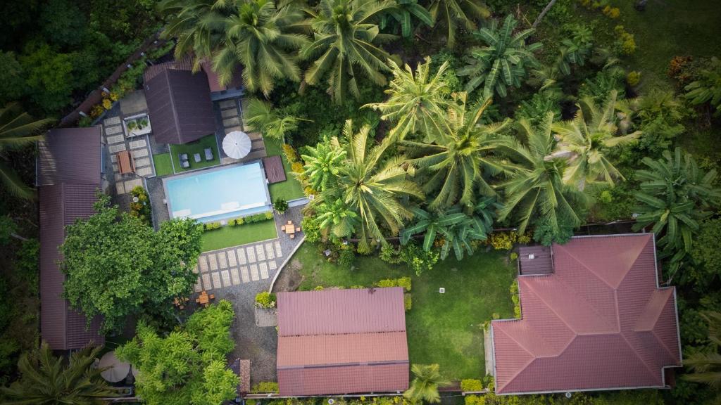 an overhead view of a house with palm trees at Rue DeuxVilles Villa in Loon