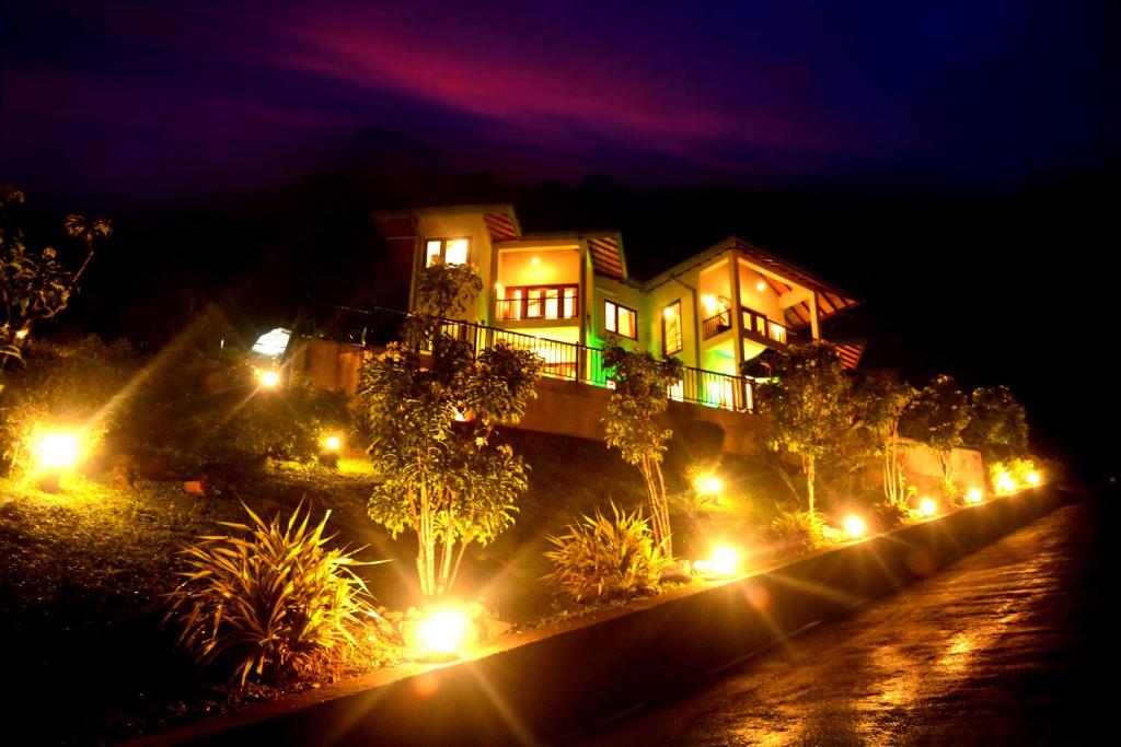 a house with lights in front of it at night at Grand Hills kandy in Kandy