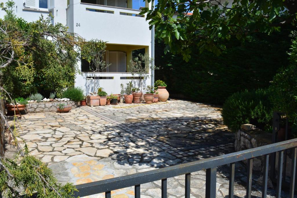 a stone walkway in front of a house at Apartment Silva in Kornić