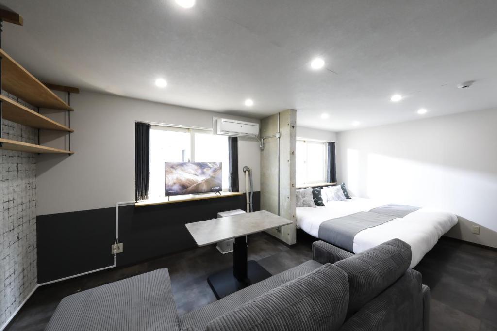 a hotel room with a bed and a couch at エクセル北円山 in Sapporo