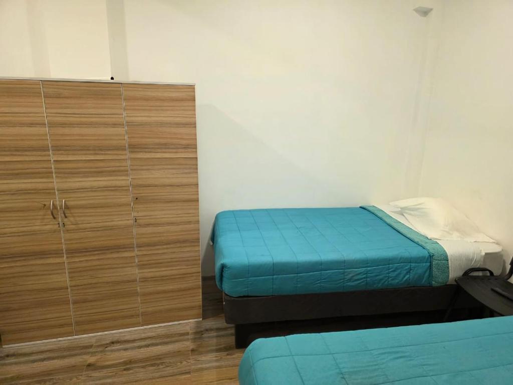 Postel nebo postele na pokoji v ubytování Hostal nancy