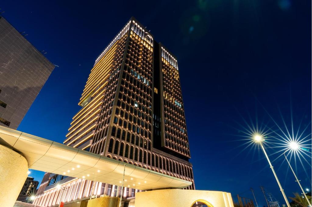 a tall building with lights in front of it at Arjuna Solitaire Hotel in Sihanoukville