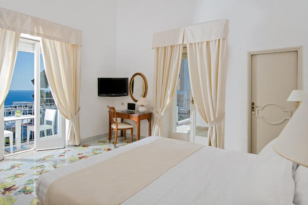 Postel nebo postele na pokoji v ubytování Hotel Syrene