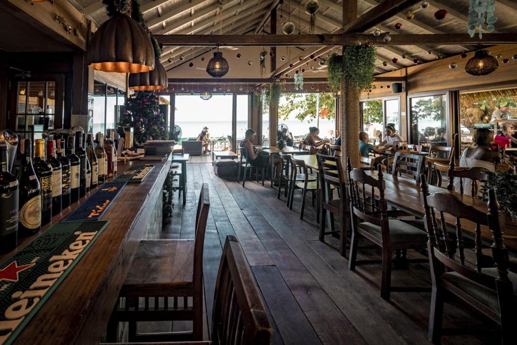 a restaurant with tables and chairs and people sitting at them at 15 Palms Beach Resort in Ko Chang