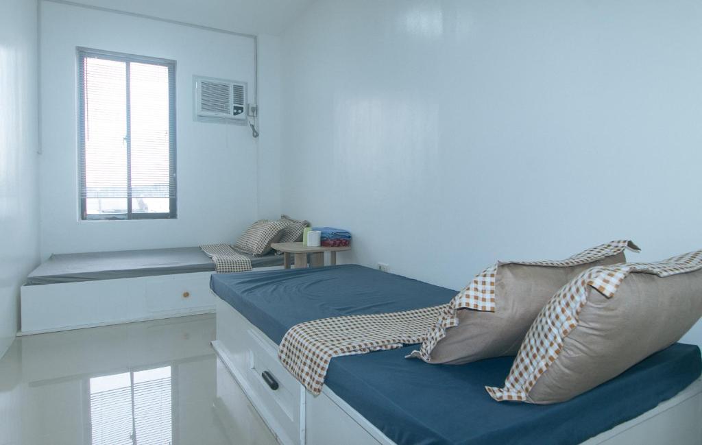 En eller flere senge i et værelse på Skybox Pension House by RedDoorz