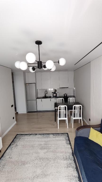 a living room with a couch and a kitchen at Марина 6 in Zhezdi