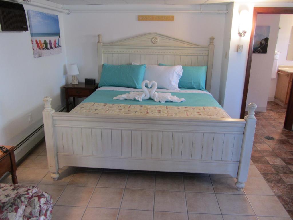 a bedroom with a bed and a dresser at Green Dolphin Motel in Old Orchard Beach