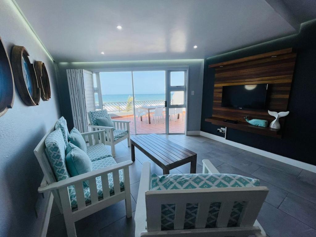 a living room with a view of the beach at Beachy Seaside Serenity in Umdloti