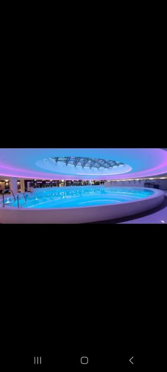 a television screen with a picture of a swimming pool at Hanza King Apartament 2 and SPA in Szczecin