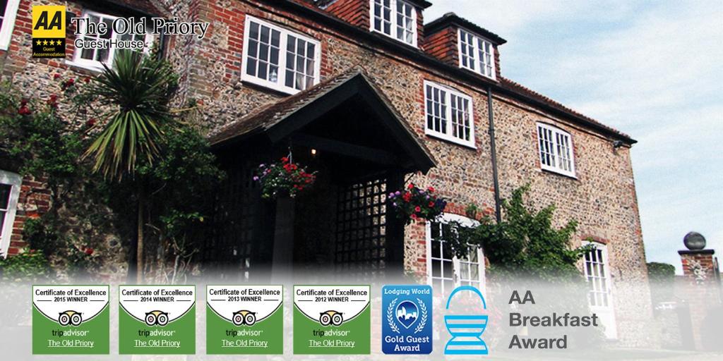 a large brick building with signs in front of it at The Old Priory B&B in Bognor Regis