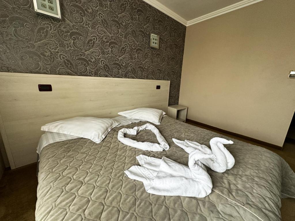 Postel nebo postele na pokoji v ubytování Grand Master Hotel
