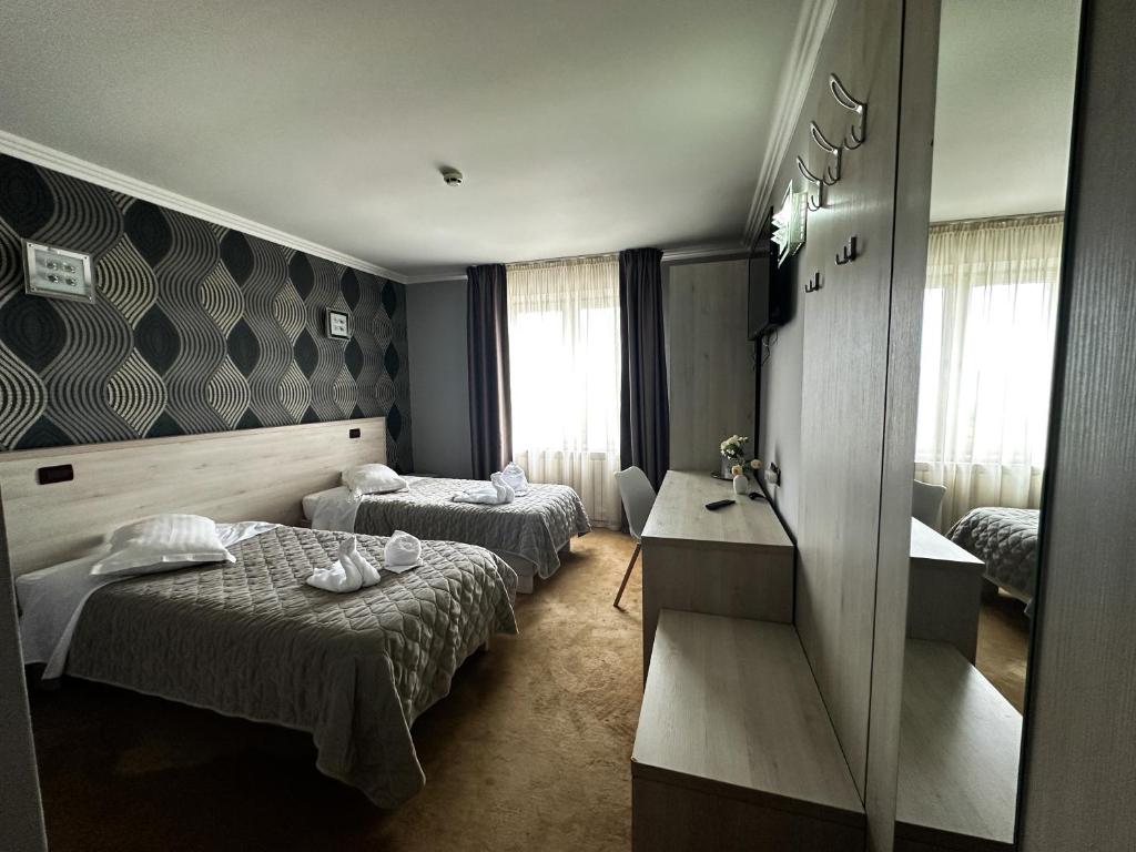 Postel nebo postele na pokoji v ubytování Grand Master Hotel