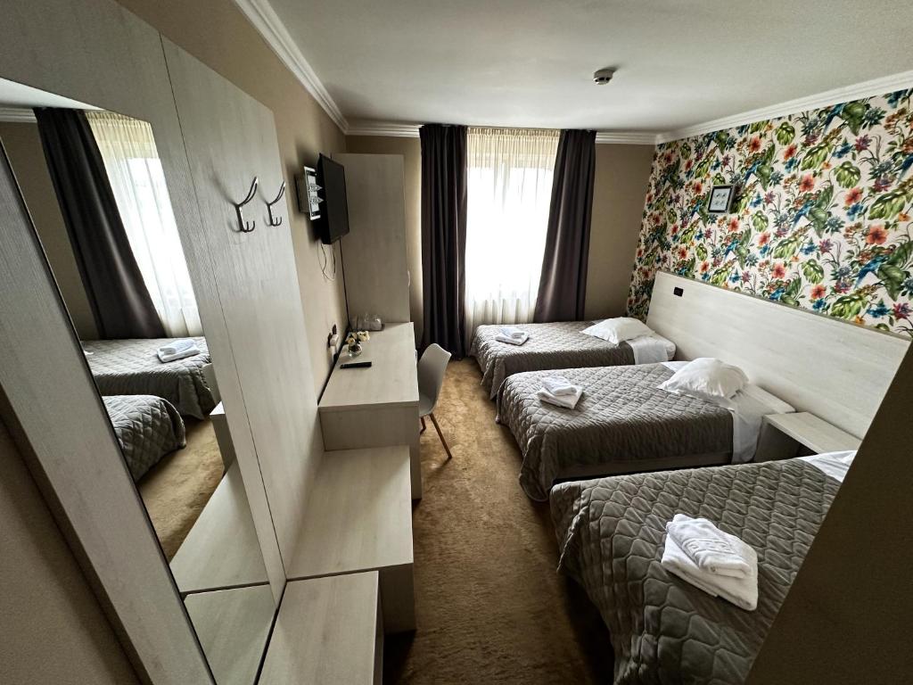 Postel nebo postele na pokoji v ubytování Grand Master Hotel