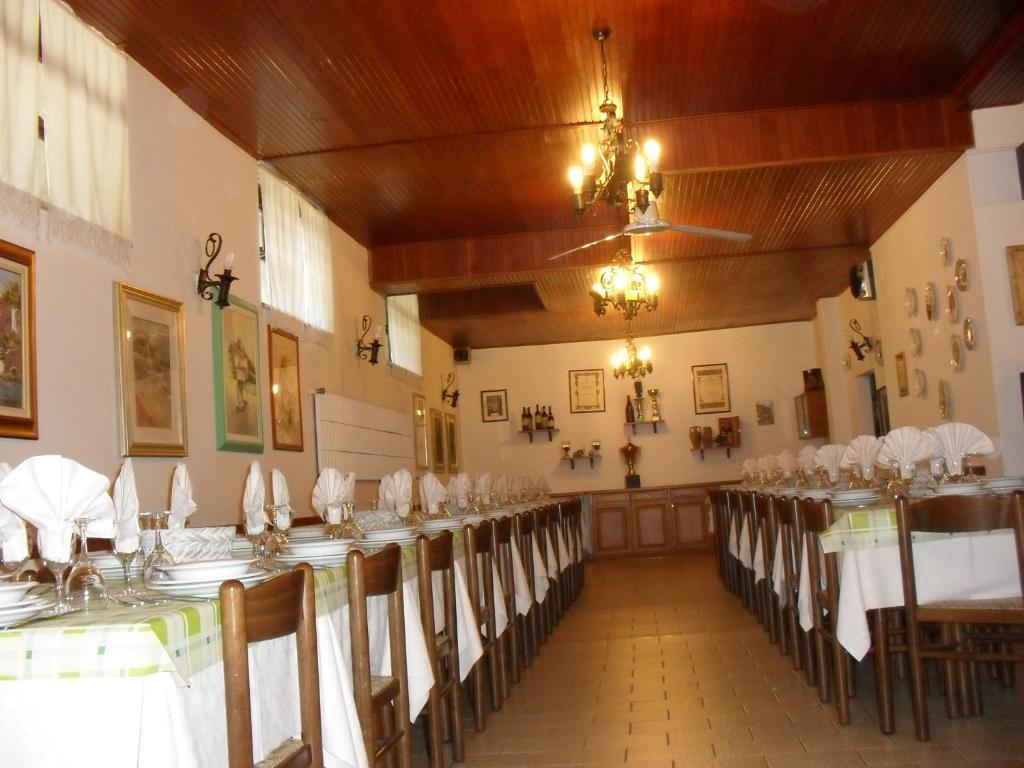 a large room with tables and chairs in it at Al Caminetto in Aosta