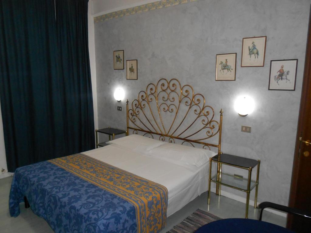 a bedroom with a bed and two side tables at Marta in Trieste