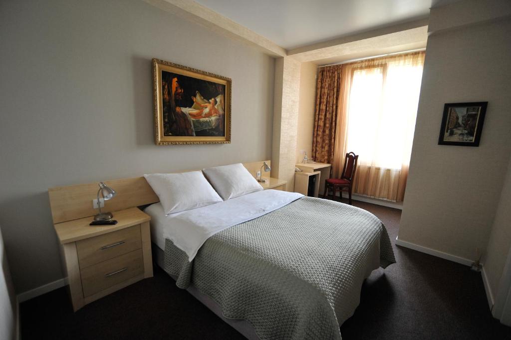 a hotel room with a bed and a desk at ZP Hotel in Tbilisi City