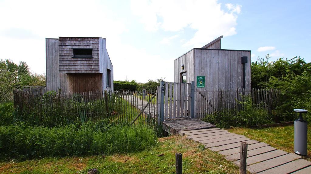 a small building with a gate and a fence at eco lodges of Mont Bernanchon in Mont-Bernenchon