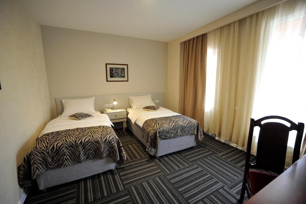 Postel nebo postele na pokoji v ubytování ZP Hotel