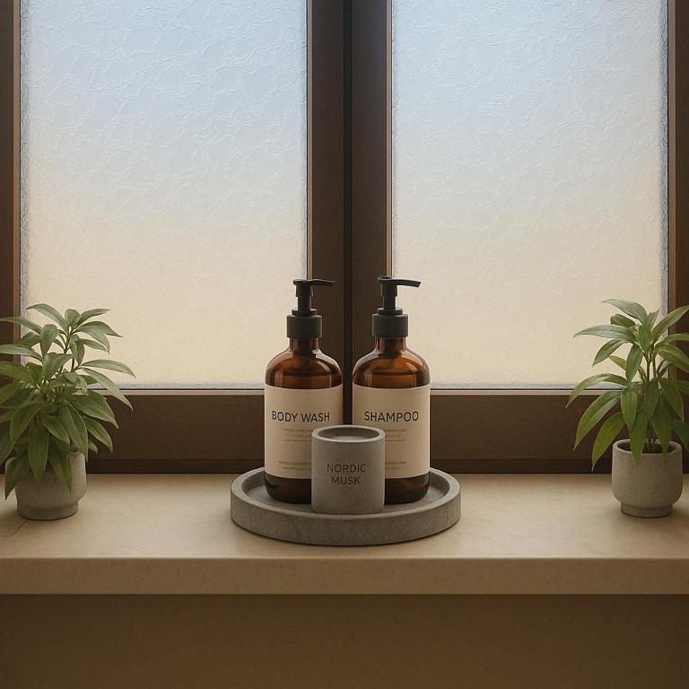 two bottles of soap and a cup on a window sill at La Casa Del Sole in Agios Leon