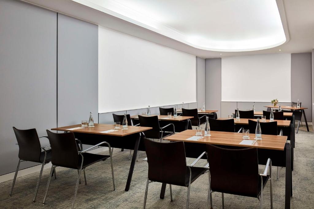 A flexible conference room arranged with several smaller meeting tables.