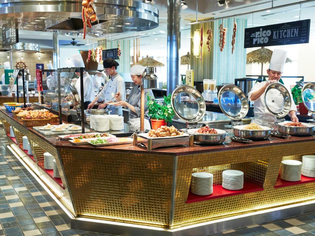 a group of chefs preparing food in a restaurant kitchen at Hotel Universal Port in Osaka