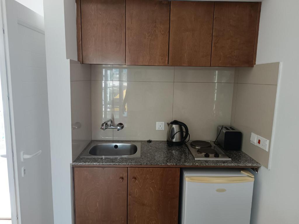 a kitchen with a sink and a counter top at Georgia Hotel Apartments in Protaras