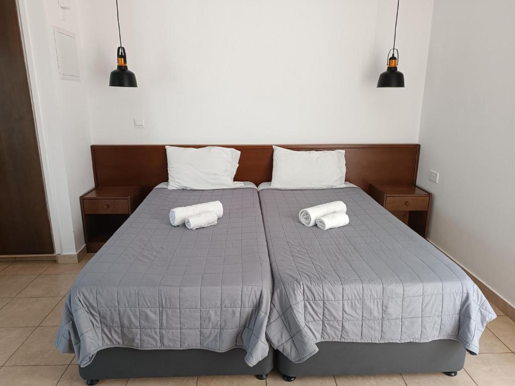 a bedroom with a bed with two towels on it at Georgia Hotel Apartments in Protaras