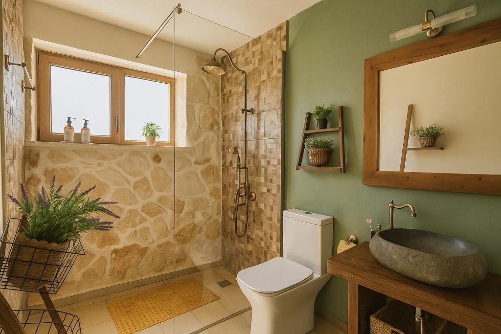 a bathroom with a shower and a toilet and a sink at La Casa Del Sole in Agios Leon