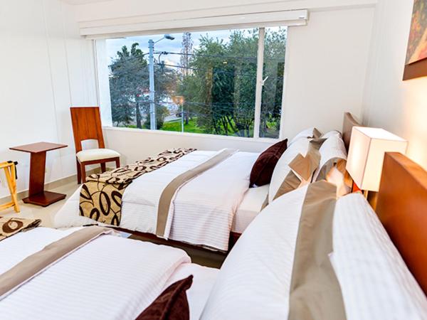 Postel nebo postele na pokoji v ubytování Hotel Fontanar Usaquen