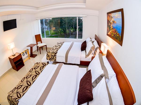Postel nebo postele na pokoji v ubytování Hotel Fontanar Usaquen