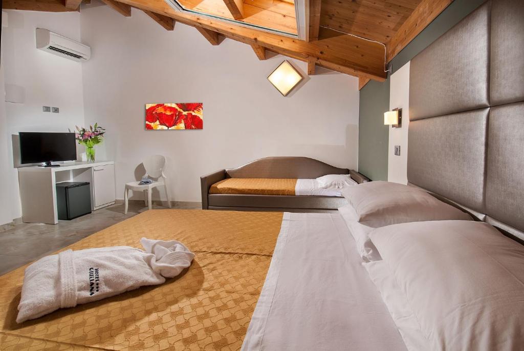 Postel nebo postele na pokoji v ubytování Hotel Giuliana