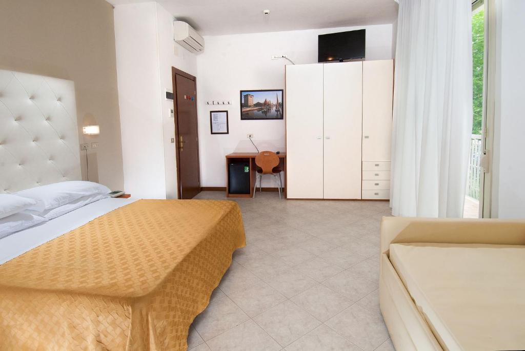 Postel nebo postele na pokoji v ubytování Hotel Giuliana