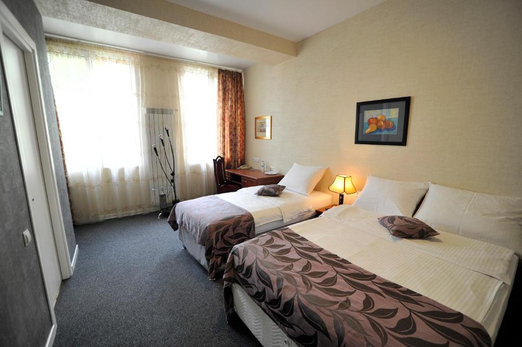Postel nebo postele na pokoji v ubytování ZP Hotel