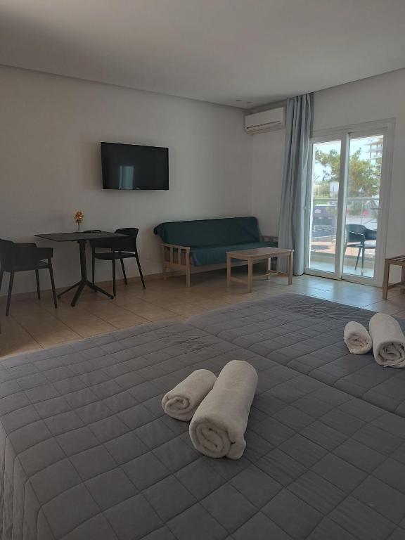 a room with a large bed with towels on it at Georgia Hotel Apartments in Protaras