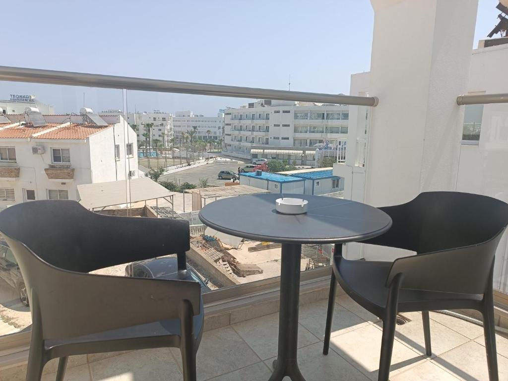 a table and chairs on a balcony with a view at Georgia Hotel Apartments in Protaras