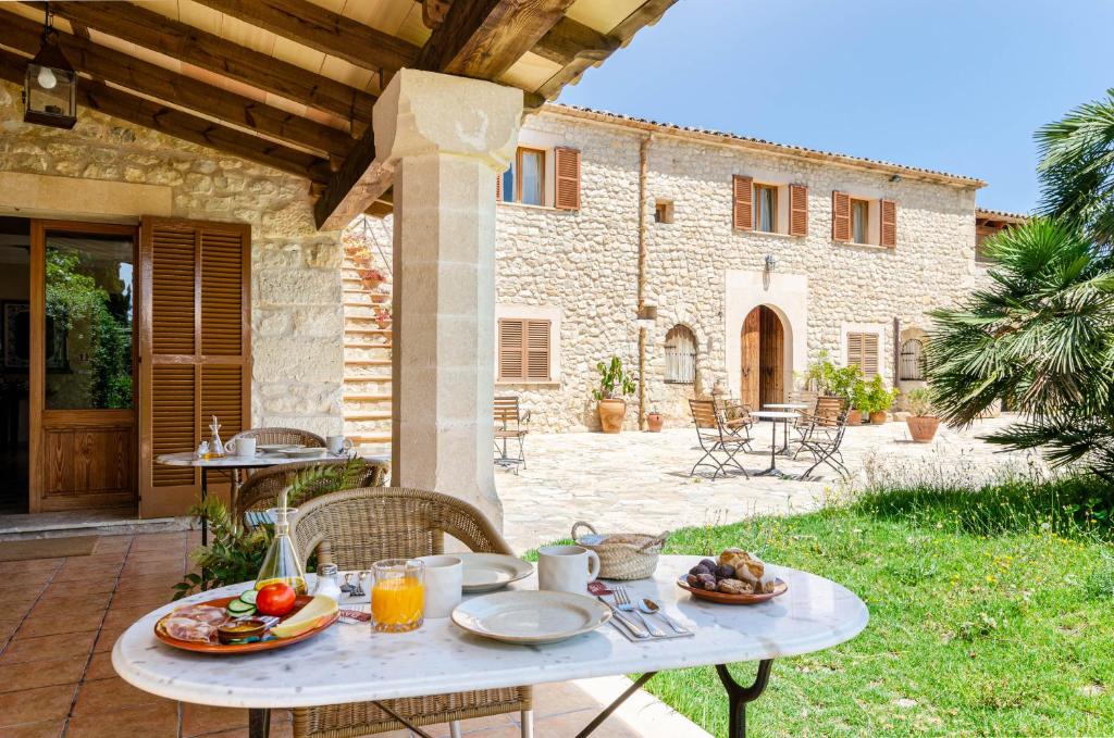 a table with plates of food on a patio at Finca es Rafal, Agroturisme in Montuiri