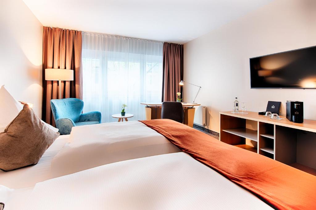 Postel nebo postele na pokoji v ubytování Welcome Hotel Marburg