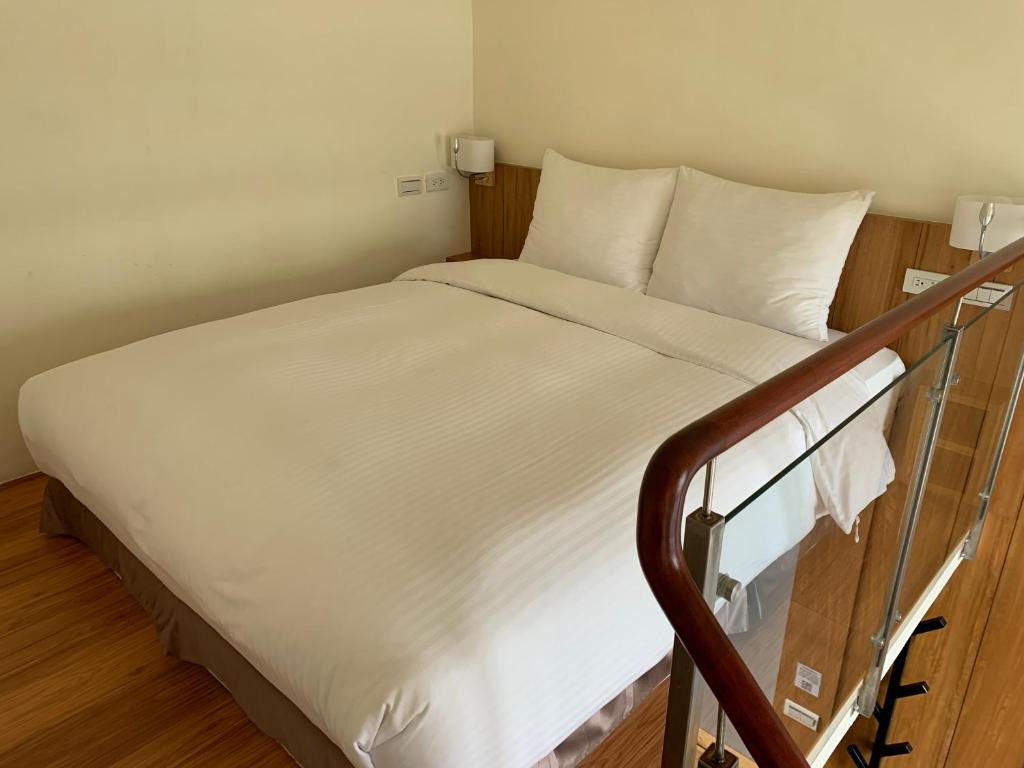 Postel nebo postele na pokoji v ubytování Anping Kensington Hotel
