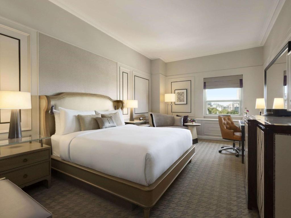 a hotel room with a large bed and a desk at Fairmont Le Chateau Frontenac in Quebec City
