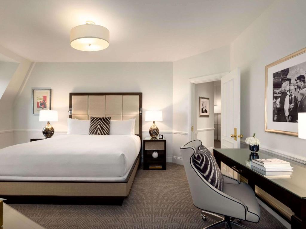 a hotel room with a bed and a desk and a desk at Fairmont Le Chateau Frontenac in Quebec City