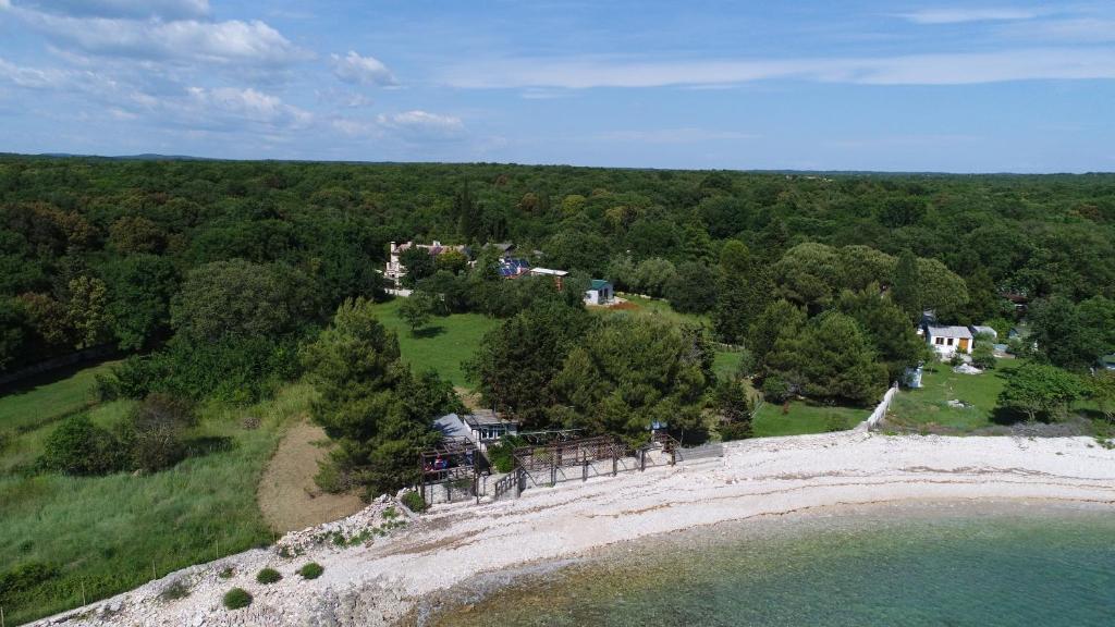 an aerial view of a house on a hill near the water at ECO Beach Houses - Pet friendly in Peroj