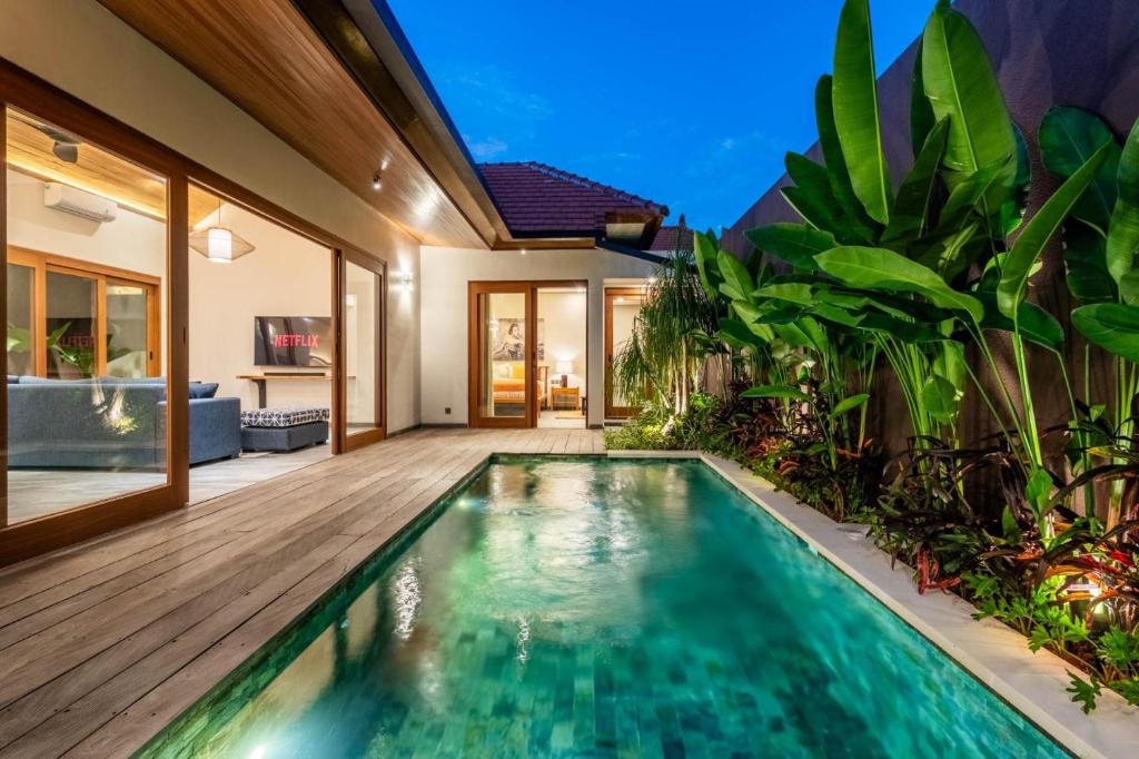 an indoor swimming pool in a villa with a house at Villa Domus A1 in Sanur