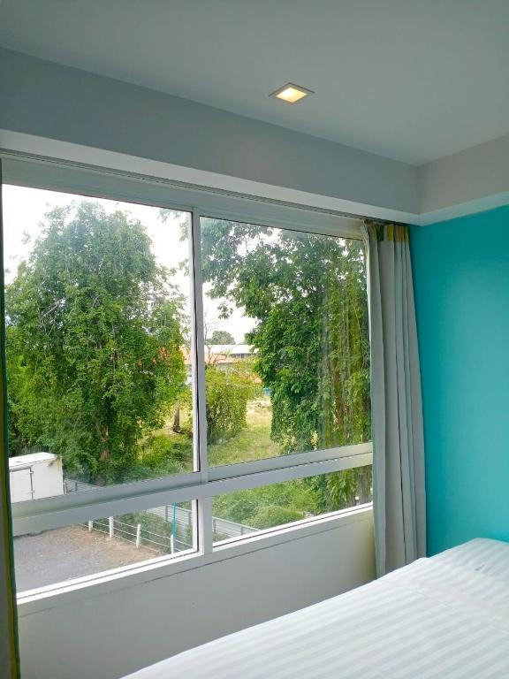 Postel nebo postele na pokoji v ubytování Nantra Chaweng Beach Hotel