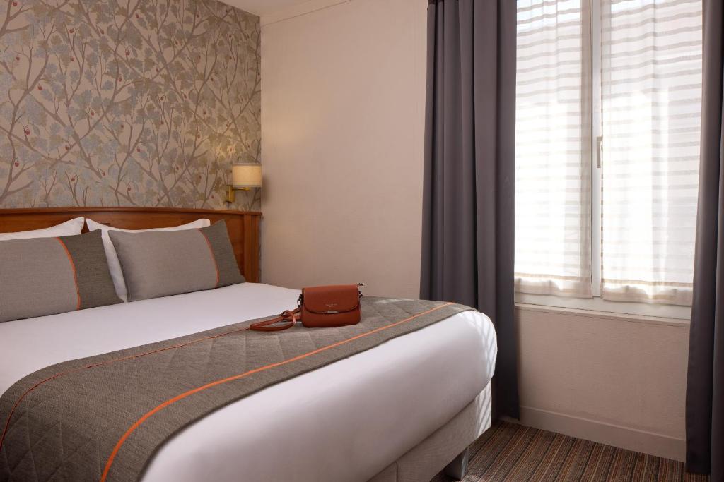 Postel nebo postele na pokoji v ubytování Timhotel Tour Eiffel