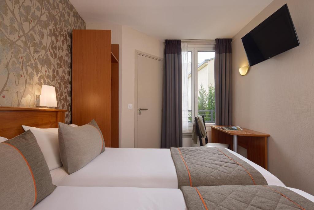 Postel nebo postele na pokoji v ubytování Timhotel Tour Eiffel